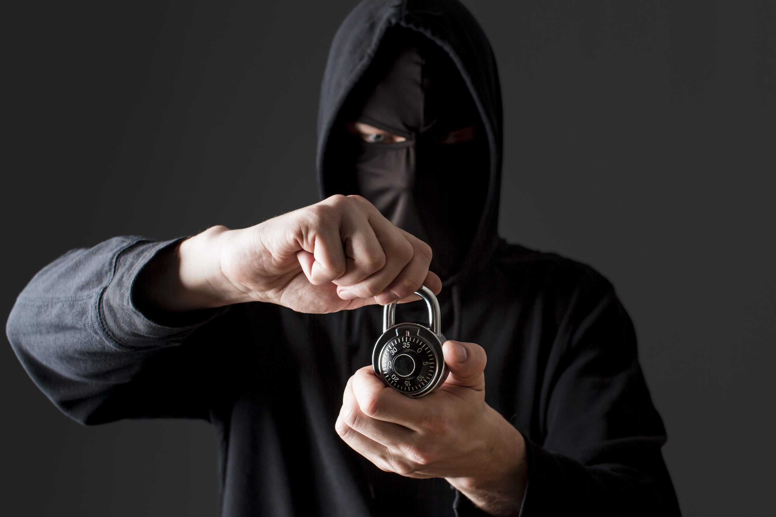 male-hacker-holding-lock