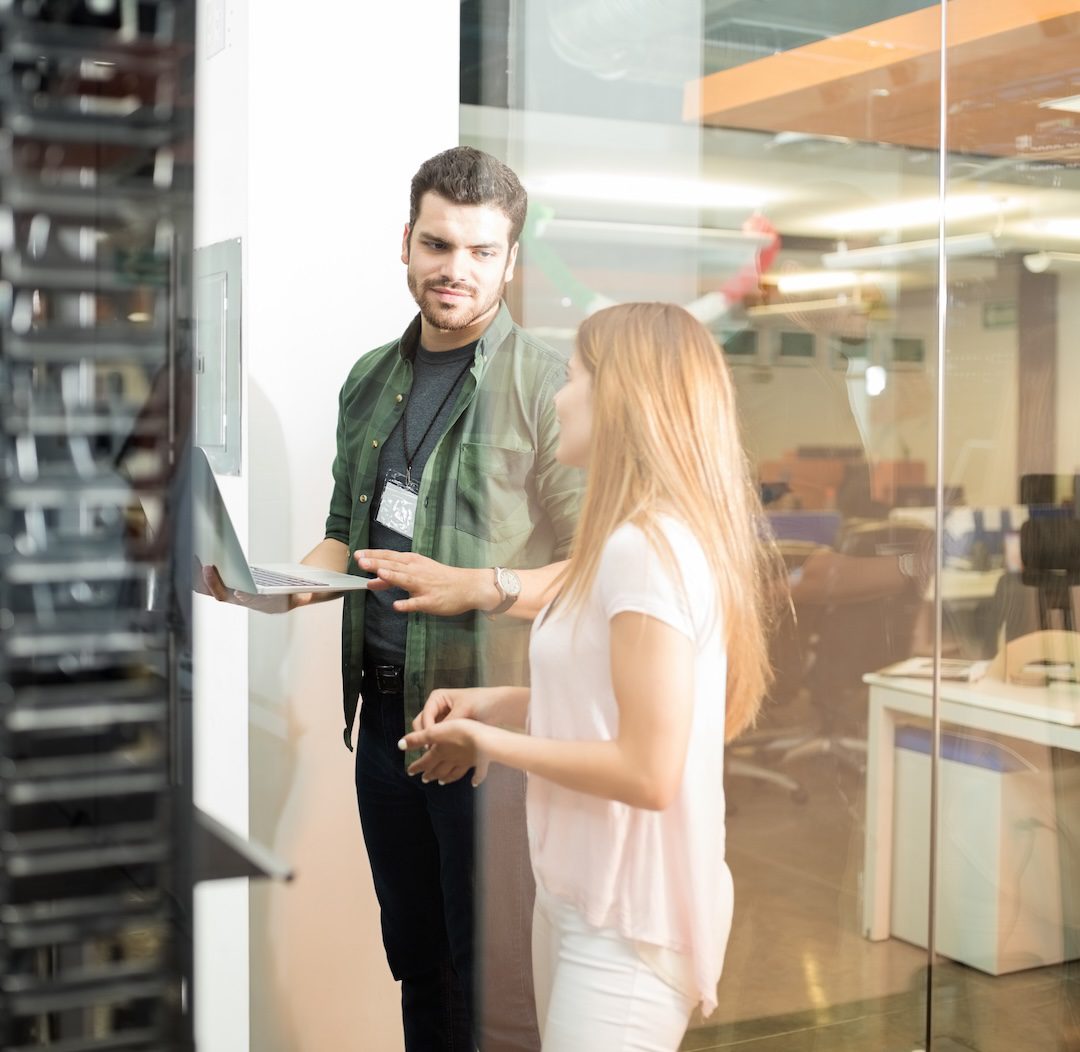 Colleagues discussing in office server room