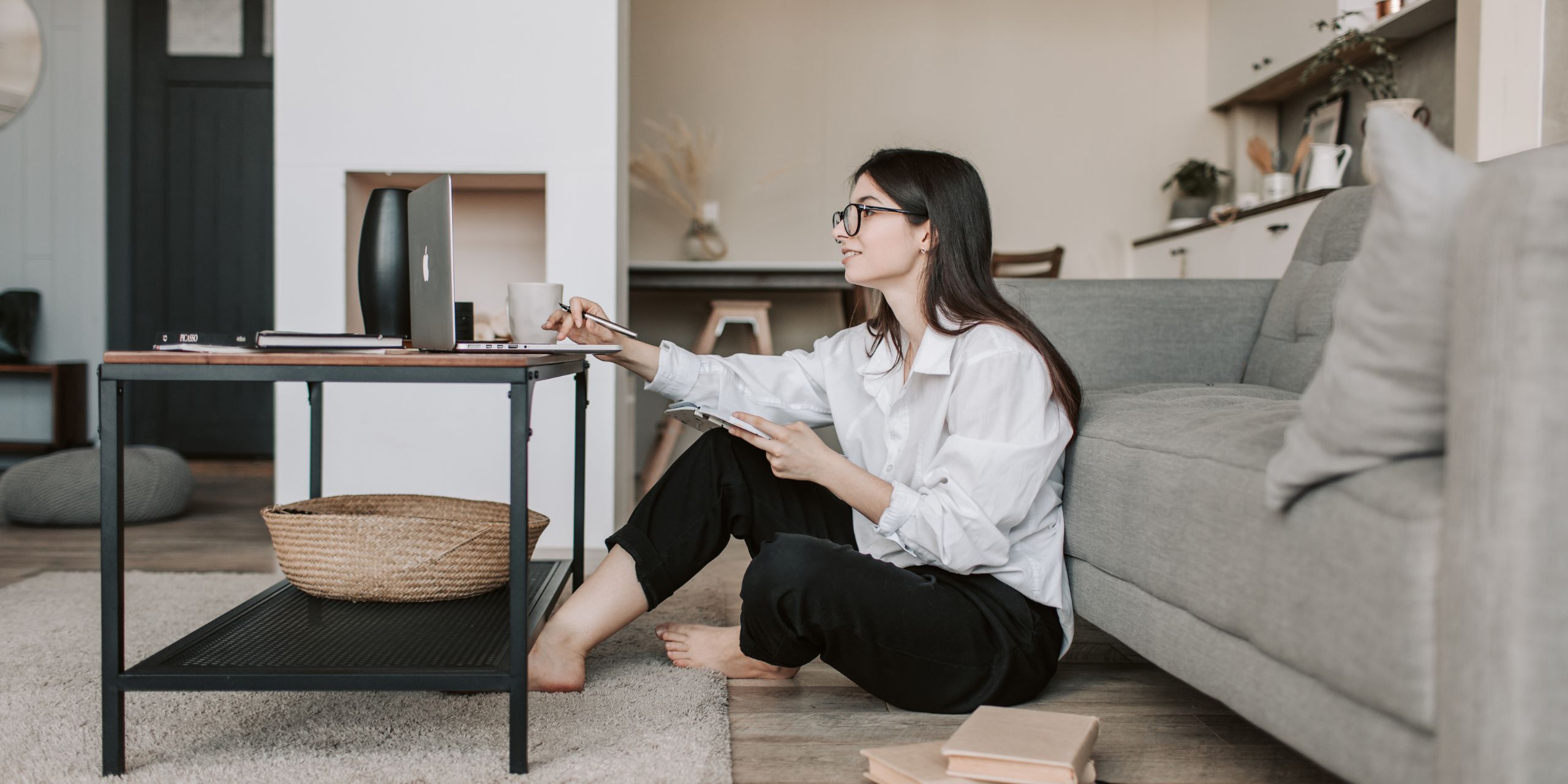 Remote employee working securely on a laptop while cybersecurity risks are monitored in the background.